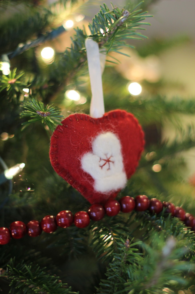 This mitten is needle felted onto a felt heart.